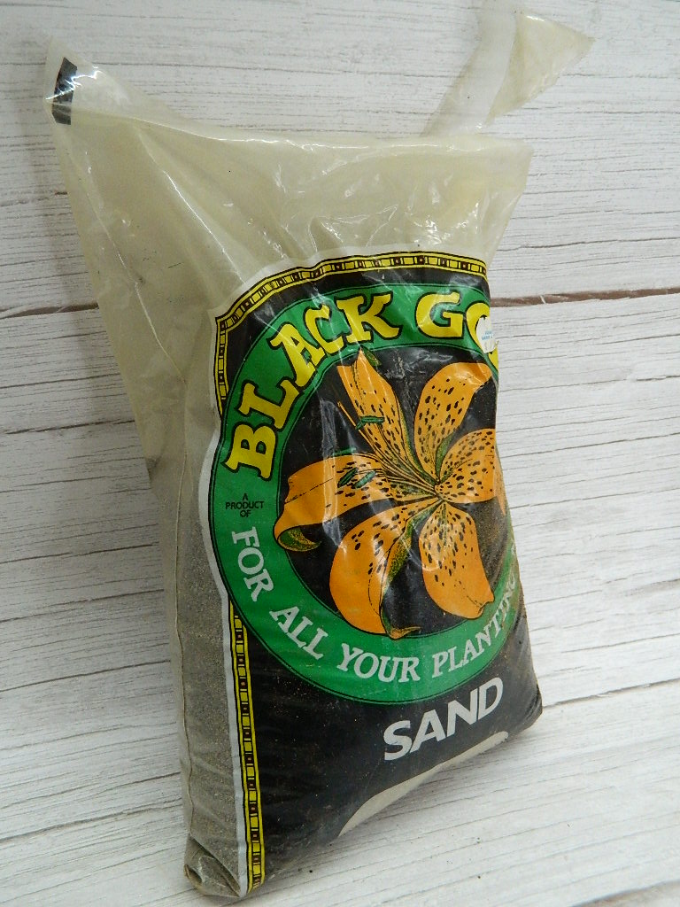 OE0008 Mostly Full Bag of Black, Gold Planting Sand, Bag is 4 Dry